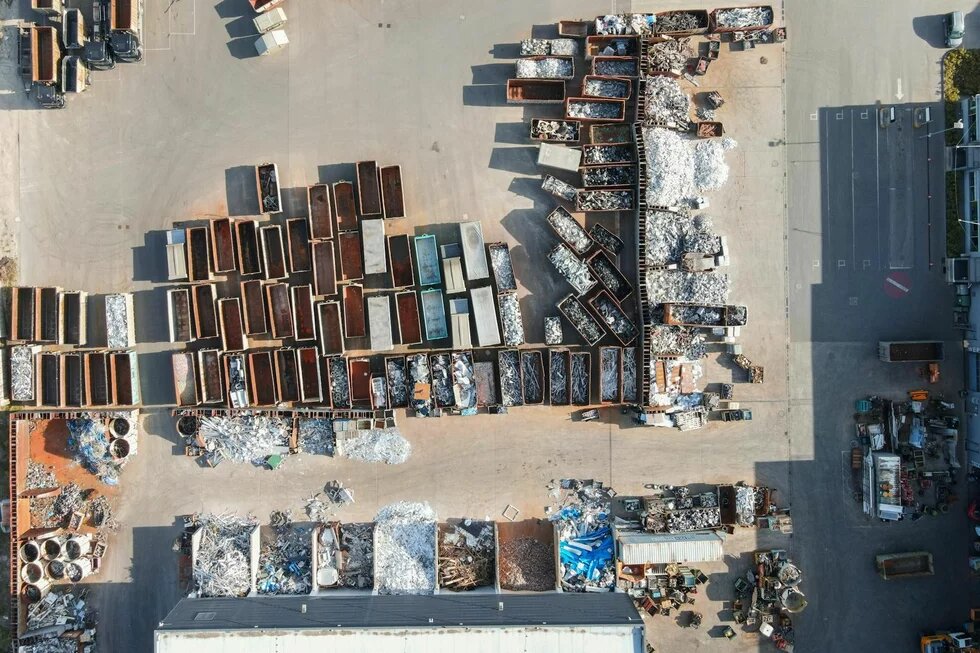 Junkyard Photo: Aerial view of a junkyard with numerous containers filled with metal and aluminum scrap. Piles and piles of recyclable material.